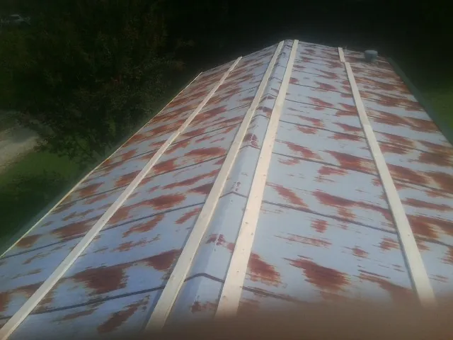 Rusted metal roof panels with new wood purlins before replacement — Storm Damage Roof Repair in Kevil by Roofing Brothers
