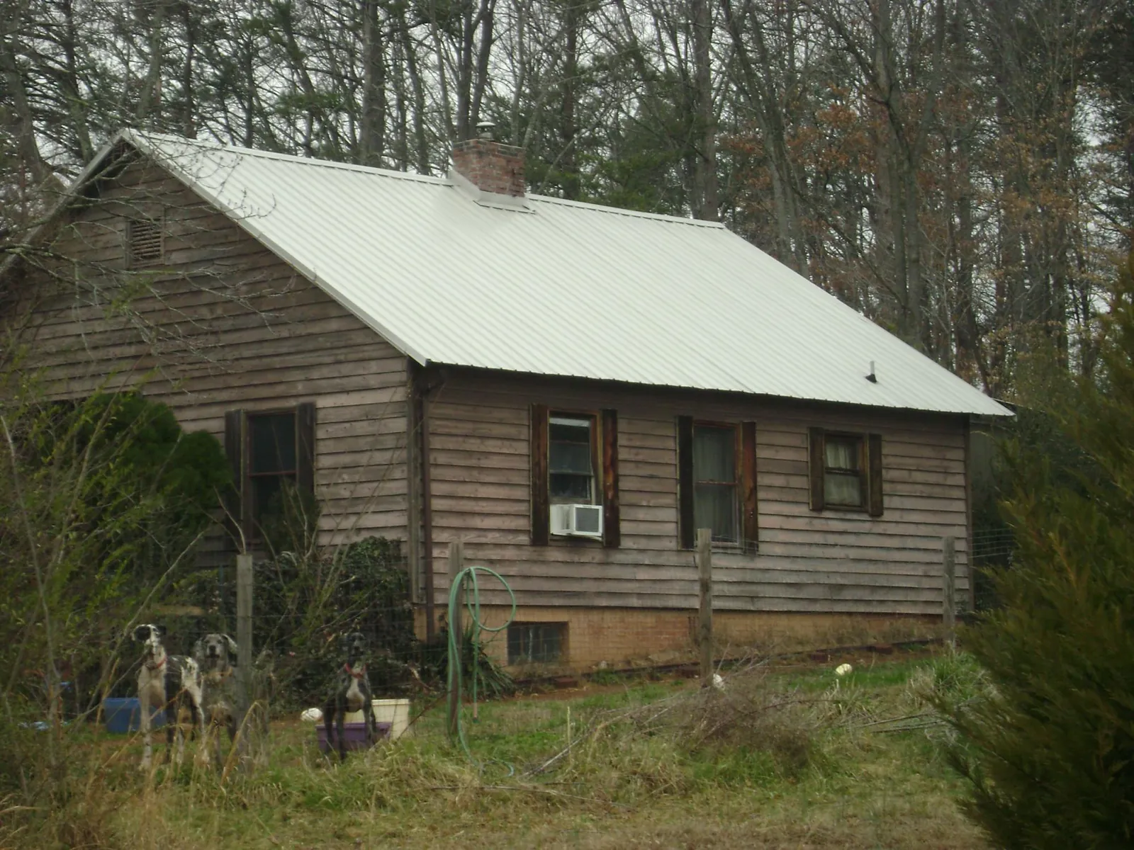 White metal roof on an old wood sided farmhouse, from a Metal Roof Installation job in Kevil